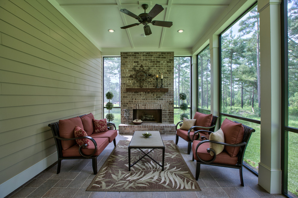 This is an example of an arts and crafts backyard screened-in verandah in Atlanta with tile and a roof extension.