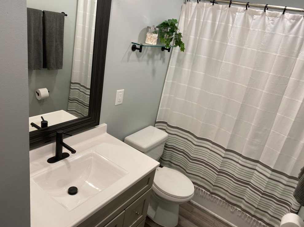 Inspiration for a large transitional l-shaped vinyl floor and gray floor open concept kitchen remodel in Cincinnati with an undermount sink, raised-panel cabinets, white cabinets, granite countertops, multicolored backsplash, ceramic backsplash, stainless steel appliances, an island and black countertops