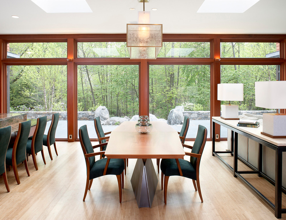 Contemporary open plan dining in Boston with light hardwood floors.