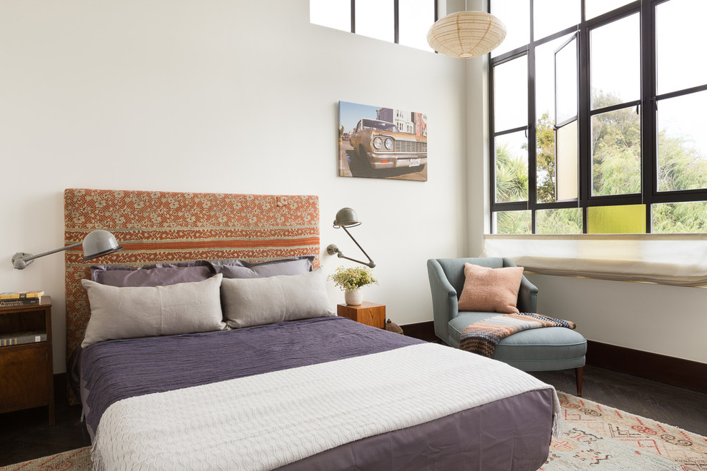 Inspiration for an eclectic bedroom in San Francisco with white walls and dark hardwood floors.