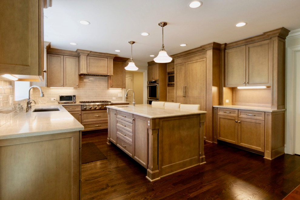 Example of a transitional kitchen design in Chicago with an island