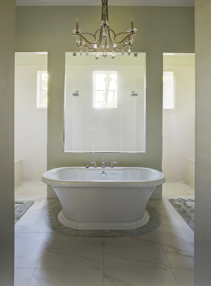 This is an example of a large transitional master bathroom in Jacksonville with shaker cabinets, white cabinets, a freestanding tub, a curbless shower, a one-piece toilet, multi-coloured tile, glass sheet wall, grey walls, porcelain floors, an undermount sink, marble benchtops, white floor and an open shower.