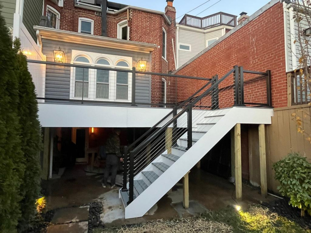 This is an example of a medium sized modern back private and first floor wire cable railing terrace in DC Metro with no cover.