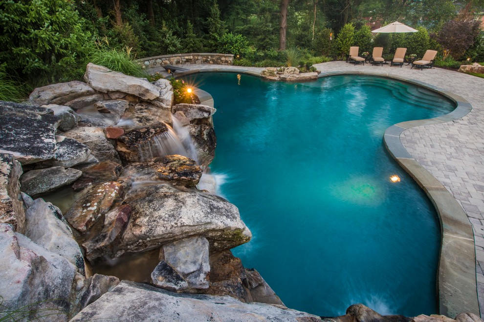 Inspiration for a mid-sized rustic backyard concrete paver and custom-shaped lap pool fountain remodel in DC Metro