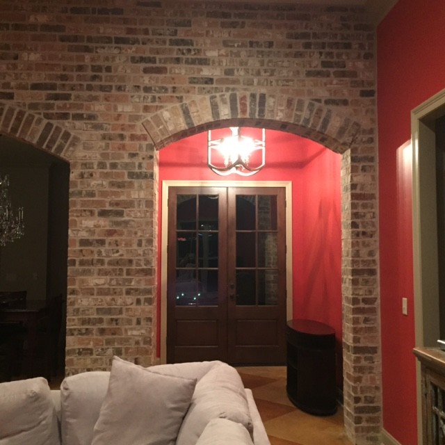 Example of a concrete floor double front door design with a dark wood front door