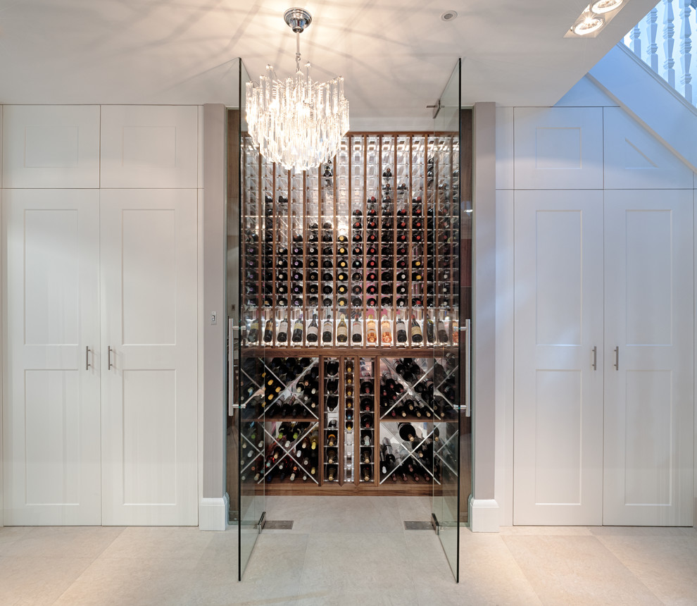 This is an example of a small contemporary wine cellar in London with storage racks.