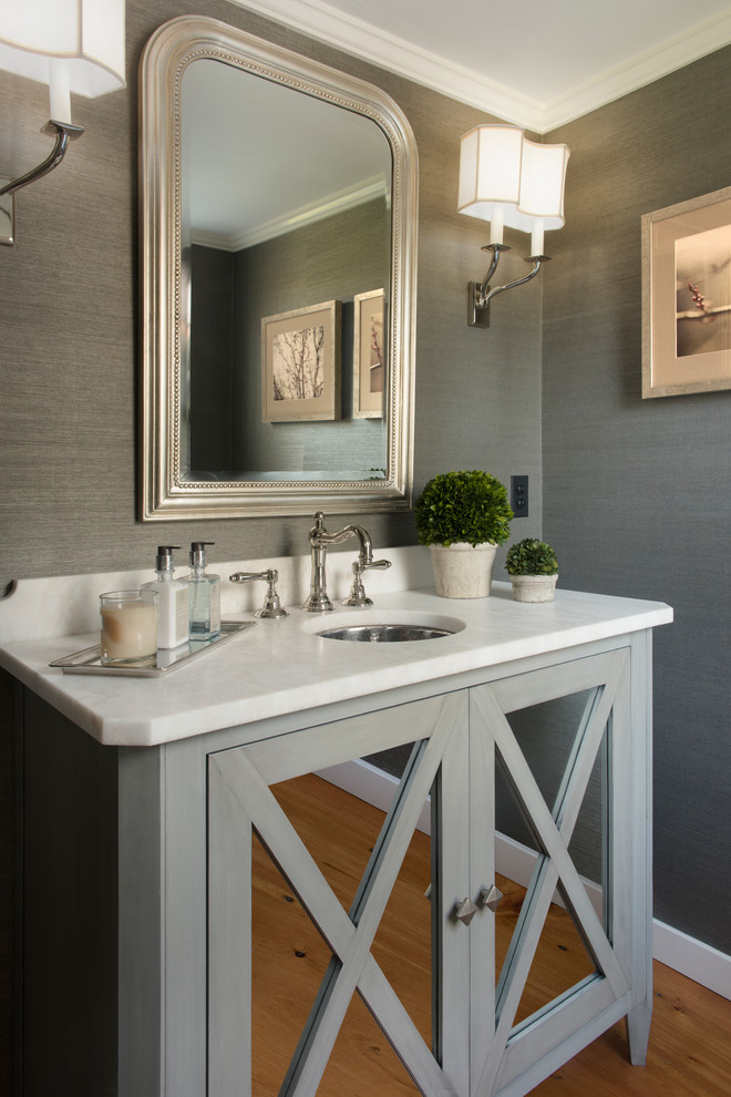 Inspiration for a traditional powder room in Boston with limestone benchtops.