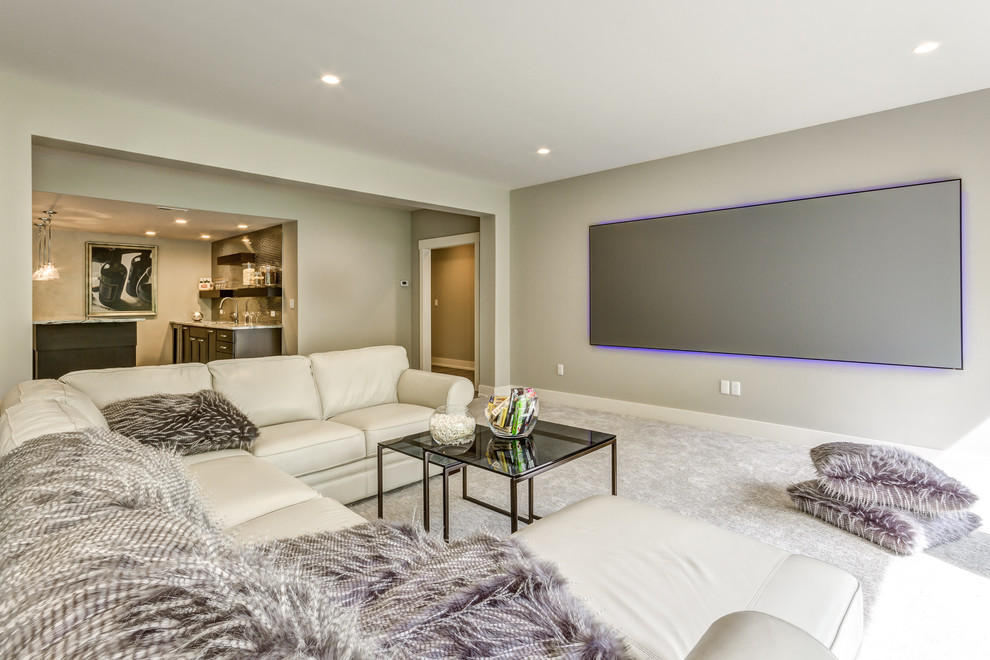 Design ideas for a transitional open concept home theatre in Other with grey walls, carpet, a projector screen and grey floor.
