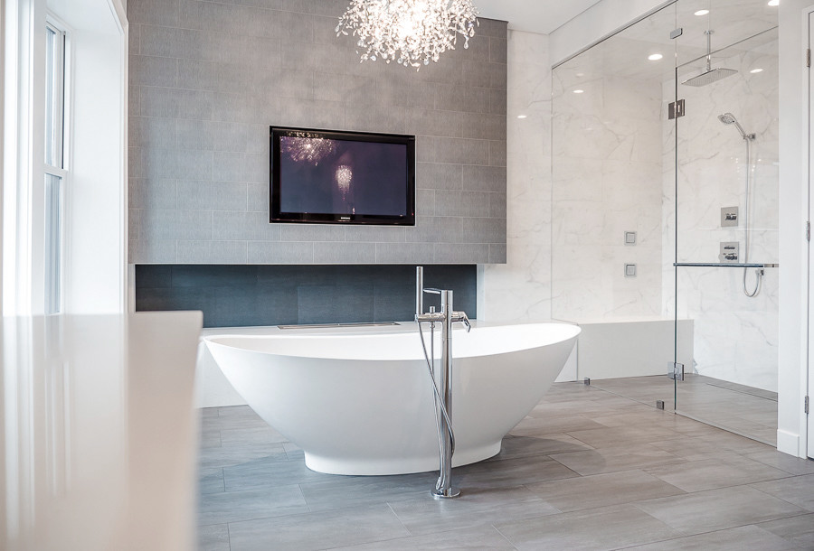 This is an example of a large contemporary master bathroom in Chicago with recessed-panel cabinets, white cabinets, a freestanding tub, an alcove shower, a two-piece toilet, beige tile, gray tile, porcelain tile, white walls, porcelain floors, an undermount sink and engineered quartz benchtops.