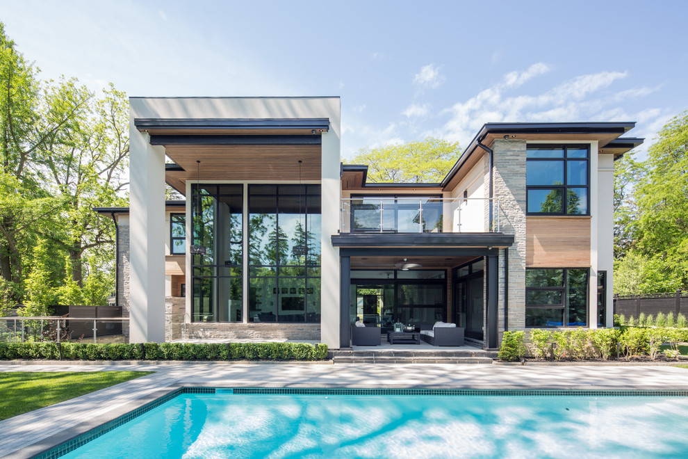 This is an example of a large contemporary two-storey brown exterior in Toronto with wood siding.