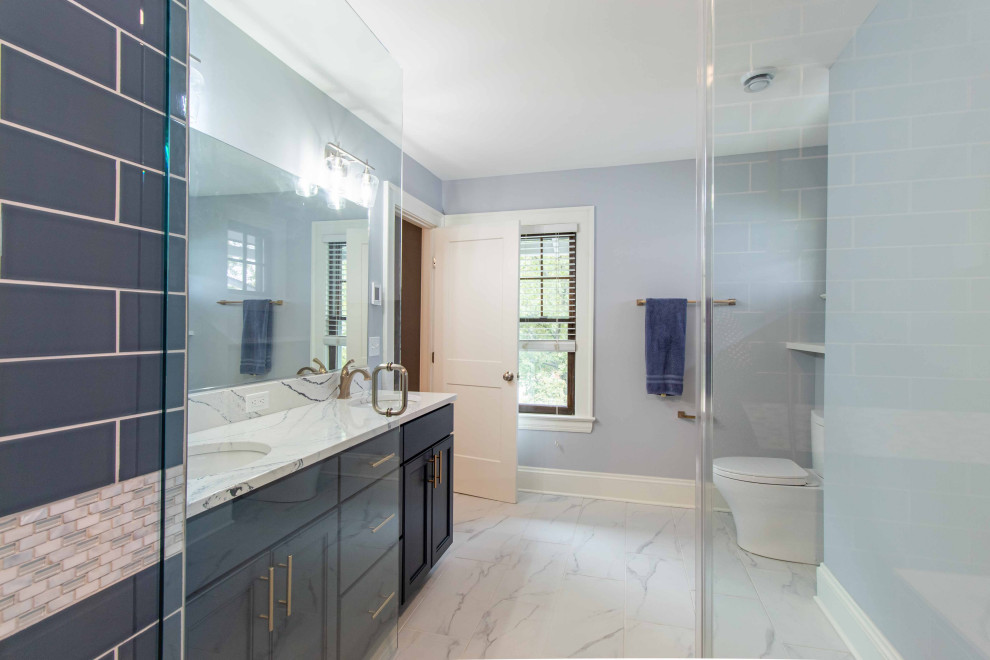Inspiration for a mid-sized contemporary master bathroom in Cleveland with shaker cabinets, blue cabinets, a one-piece toilet, grey walls, terra-cotta floors, an undermount sink, quartzite benchtops, white floor, a hinged shower door, multi-coloured benchtops, a shower seat, a double vanity and a freestanding vanity.