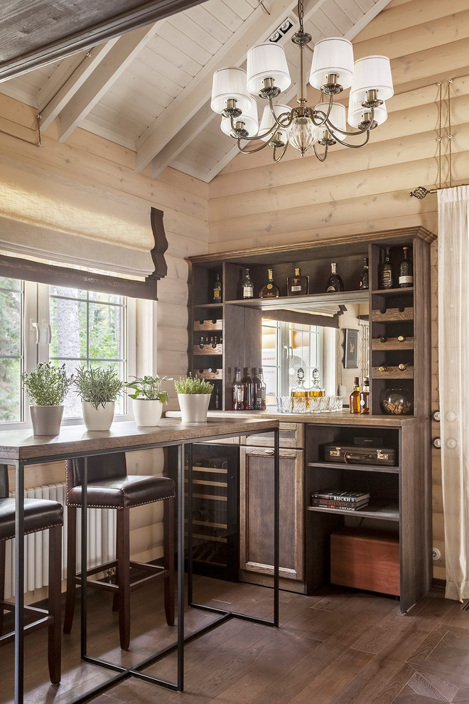 Photo of a mid-sized transitional single-wall seated home bar in Moscow with dark hardwood floors, brown floor, recessed-panel cabinets, medium wood cabinets, brown benchtop, no sink, wood benchtops and mirror splashback.