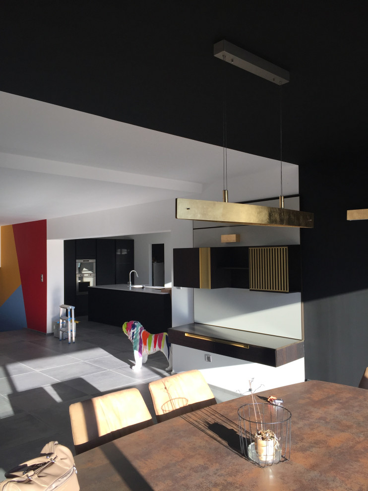 Photo of a large contemporary open concept family room in Montpellier with multi-coloured walls, ceramic floors and grey floor.