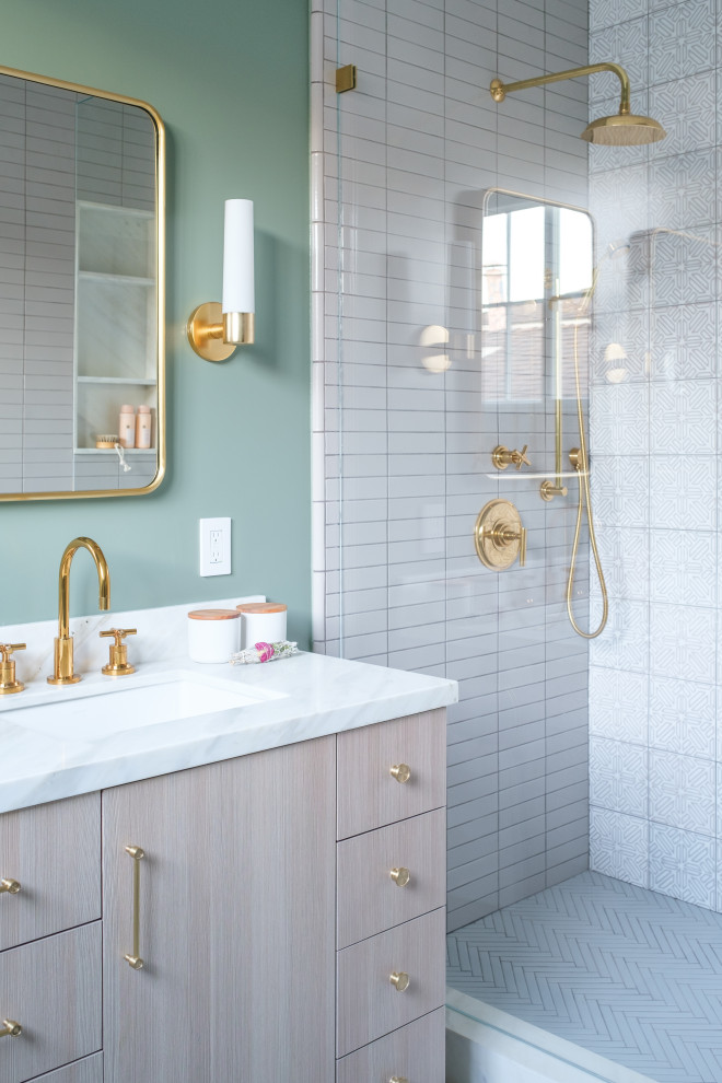 This is an example of a transitional bathroom in San Francisco with flat-panel cabinets, light wood cabinets, an alcove shower, white tile, green walls, an undermount sink, white floor and white benchtops.