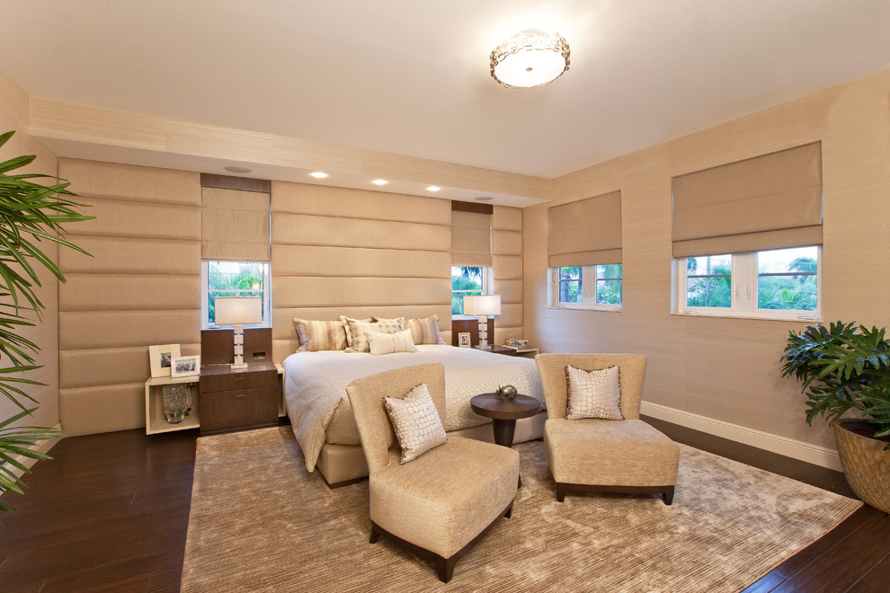 This is an example of a large transitional master bedroom in Miami with beige walls, dark hardwood floors and no fireplace.