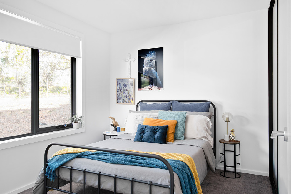 Contemporary bedroom in Hobart with white walls, carpet and grey floor.