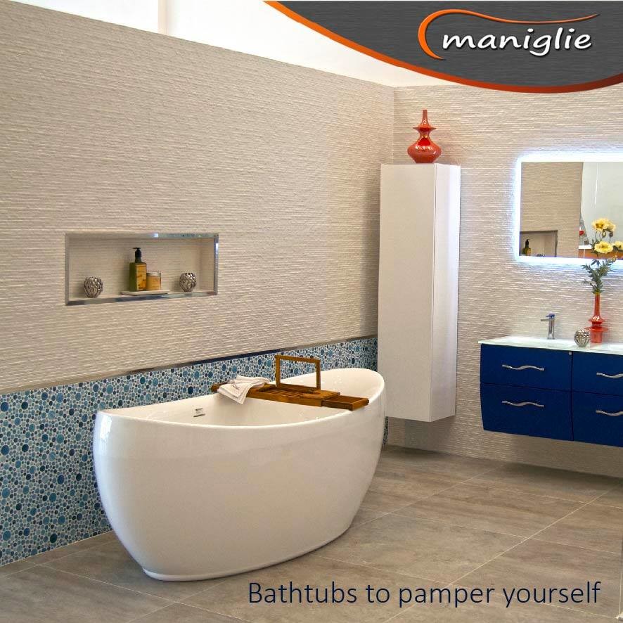 Contemporary bathroom in Miami with blue cabinets, a freestanding tub, white tile and glass benchtops.
