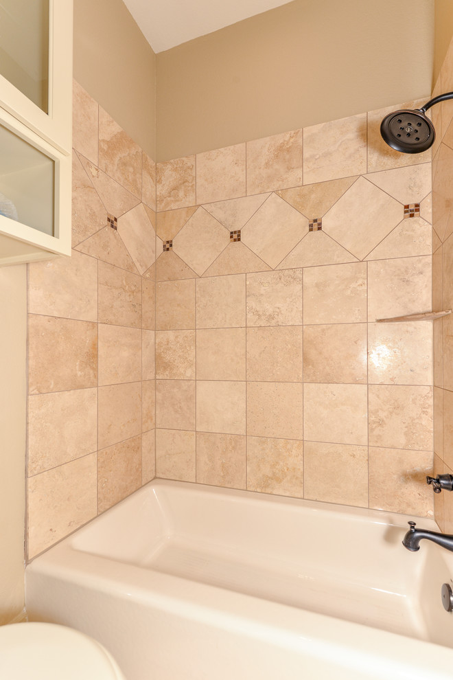 Design ideas for a mid-sized country kids bathroom in Other with raised-panel cabinets, beige cabinets, a shower/bathtub combo, a two-piece toilet, beige tile, travertine, beige walls, travertine floors, an undermount sink, granite benchtops, an alcove tub and a shower curtain.