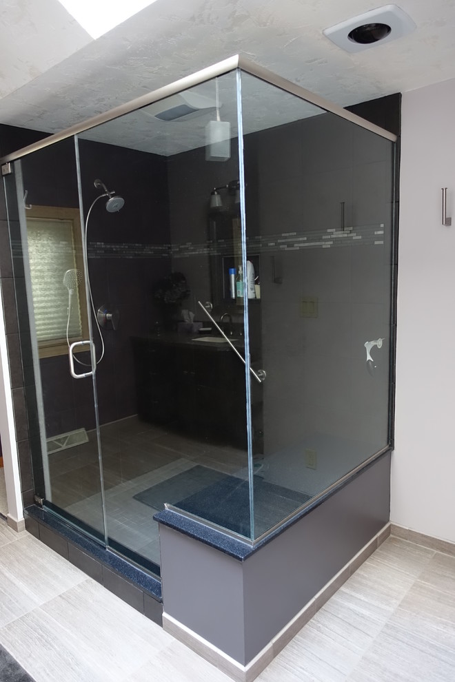 Example of a large transitional porcelain tile corner shower design with white walls