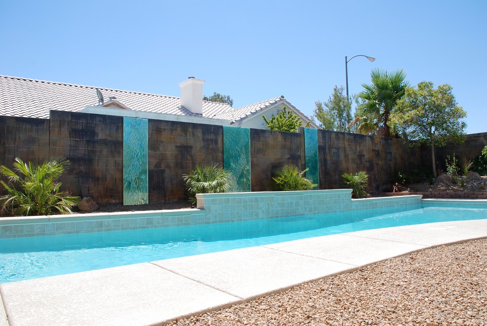 Inspiration for a large beach style backyard garden in Las Vegas with a water feature.