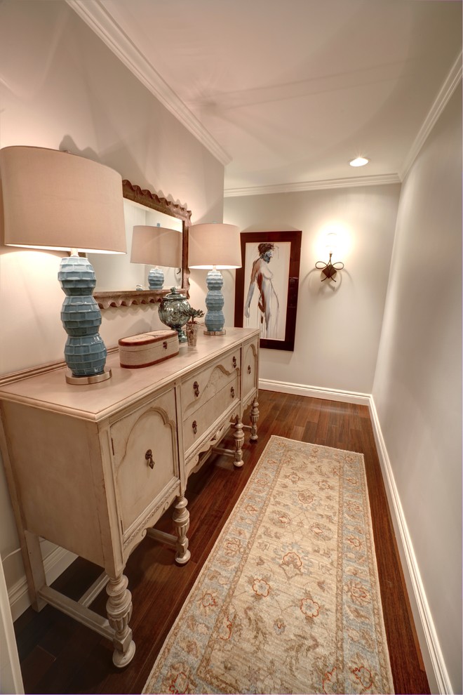 This is an example of a mid-sized traditional hallway in Detroit with beige walls and dark hardwood floors.