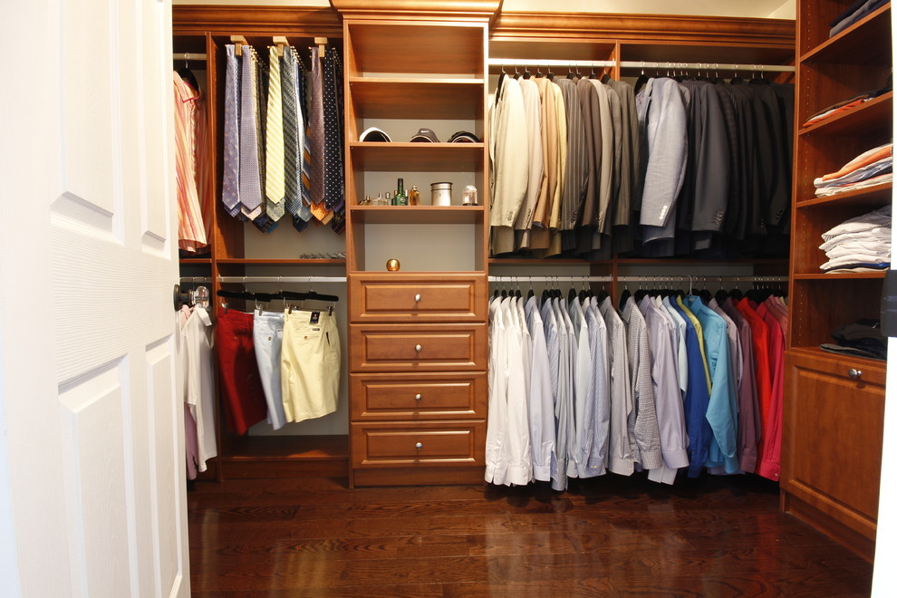 Photo of a large traditional men's walk-in wardrobe in Other with raised-panel cabinets, medium wood cabinets and medium hardwood floors.