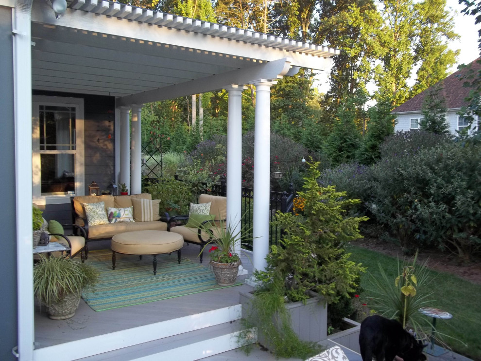 Small contemporary back metal railing veranda in Other with with columns and a pergola.