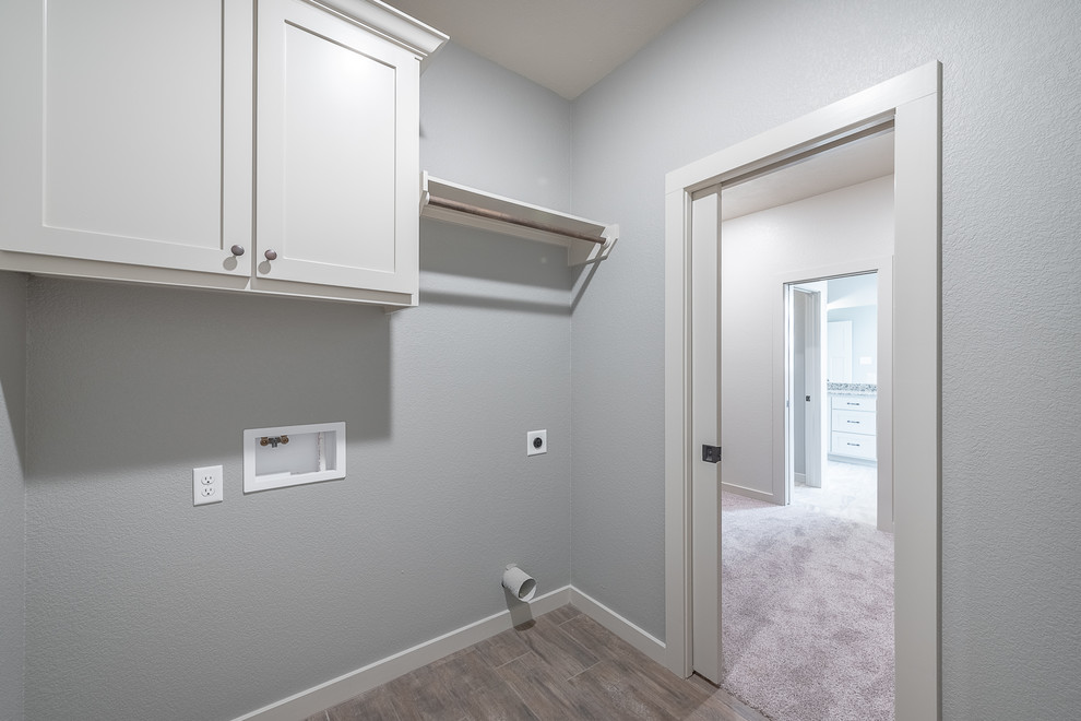 Small arts and crafts single-wall dedicated laundry room in Other with shaker cabinets, white cabinets, grey walls, ceramic floors, a side-by-side washer and dryer and beige floor.