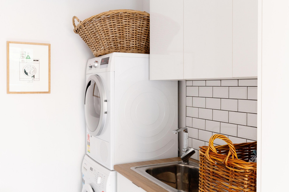 Transitional laundry room in Melbourne.