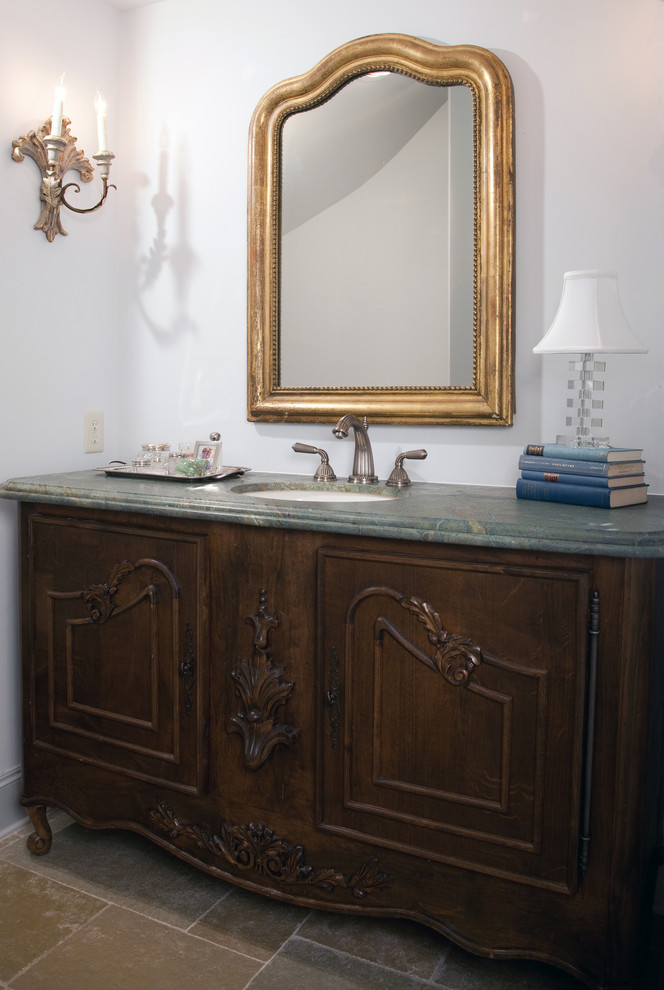 This is an example of a mid-sized transitional bathroom in Houston with medium wood cabinets, marble benchtops, blue walls and limestone floors.