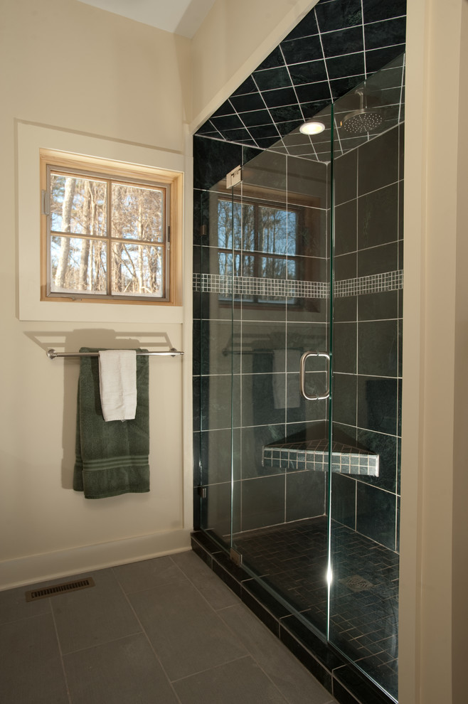 Photo of a mid-sized contemporary master bathroom in Boston with a vessel sink, shaker cabinets, dark wood cabinets, soapstone benchtops, an alcove shower, a bidet, porcelain tile, white walls, porcelain floors, black tile, grey floor, a hinged shower door and black benchtops.