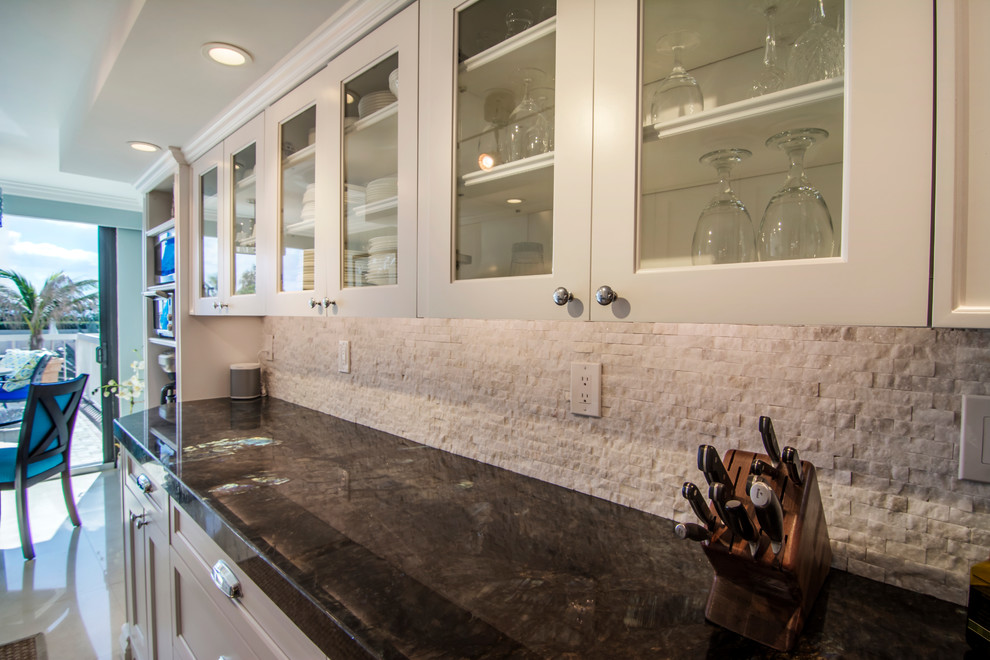 Photo of a large transitional galley kitchen pantry in Miami with an undermount sink, beaded inset cabinets, white cabinets, quartzite benchtops, white splashback, marble splashback, stainless steel appliances, marble floors, no island and beige floor.