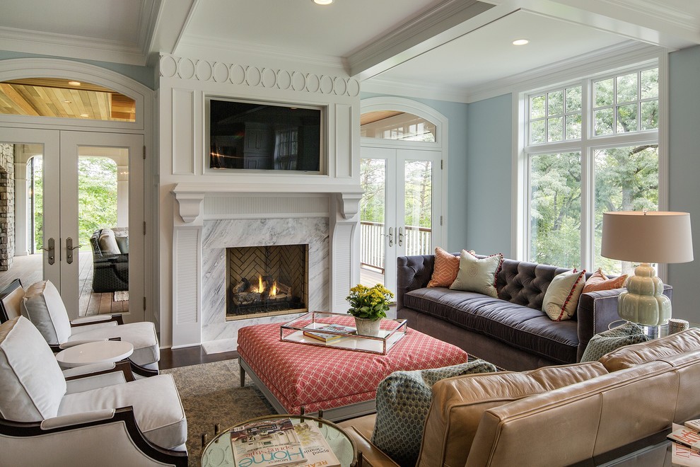 Inspiration for a traditional family room in Minneapolis with blue walls, dark hardwood floors, a standard fireplace, a tile fireplace surround and a wall-mounted tv.