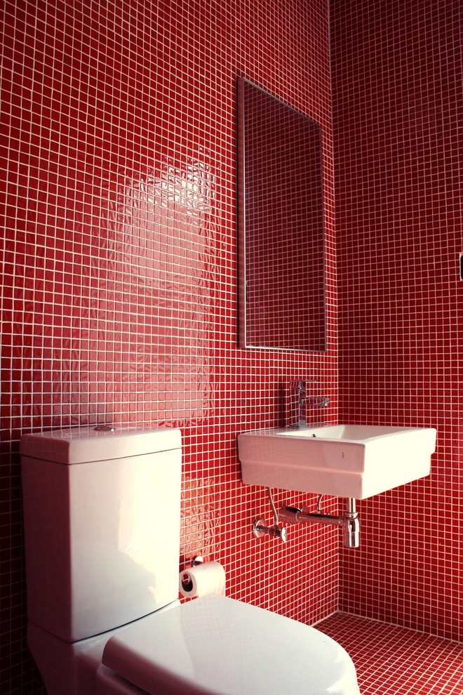 Photo of a contemporary powder room in Other with a wall-mount sink, red tile, mosaic tile, red walls and mosaic tile floors.