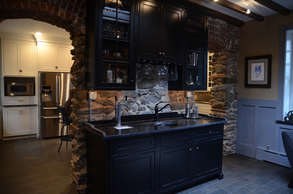 Photo of a large transitional single-wall wet bar in Philadelphia with an undermount sink, shaker cabinets, black cabinets, marble benchtops and ceramic floors.