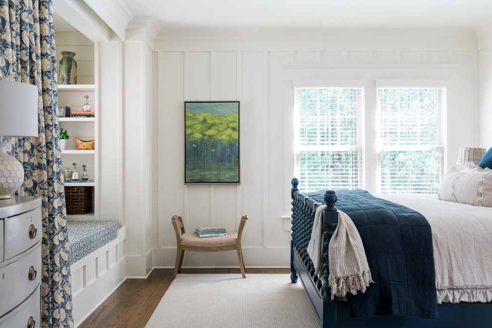 This is an example of a beach style bedroom in Atlanta with white walls, dark hardwood floors and no fireplace.