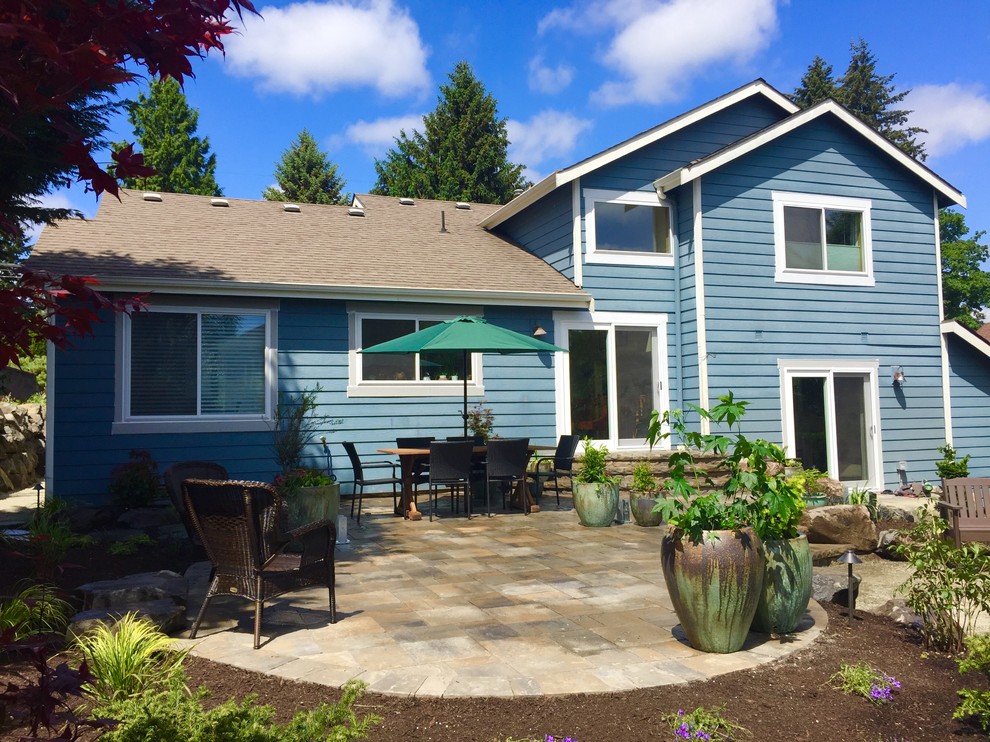 Design ideas for a mid-sized rustic backyard concrete paver landscaping in Seattle.
