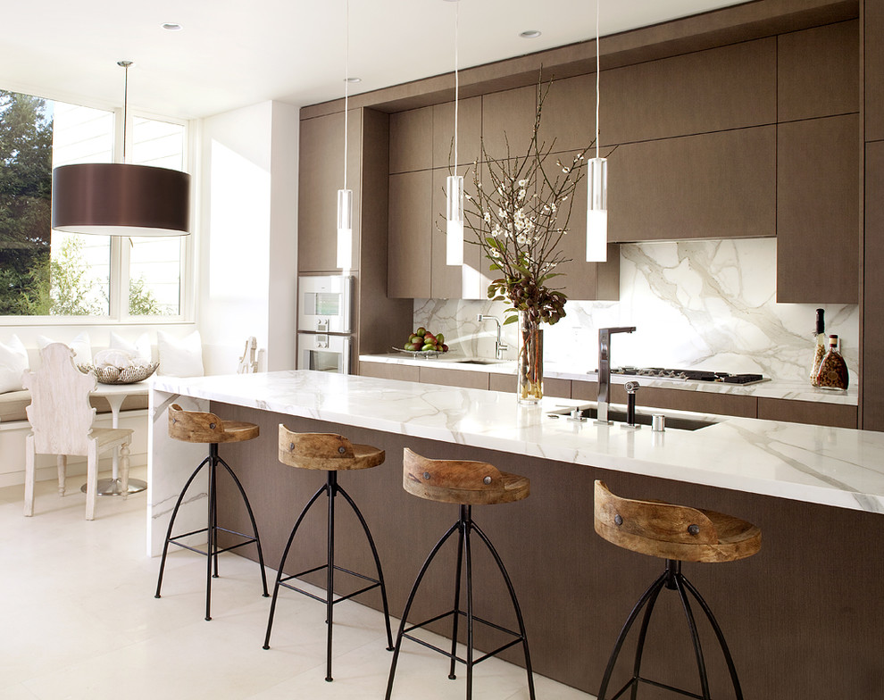 Inspiration for a contemporary galley kitchen in San Francisco with an undermount sink, flat-panel cabinets, dark wood cabinets, marble benchtops, white splashback, stone slab splashback, stainless steel appliances and white benchtop.