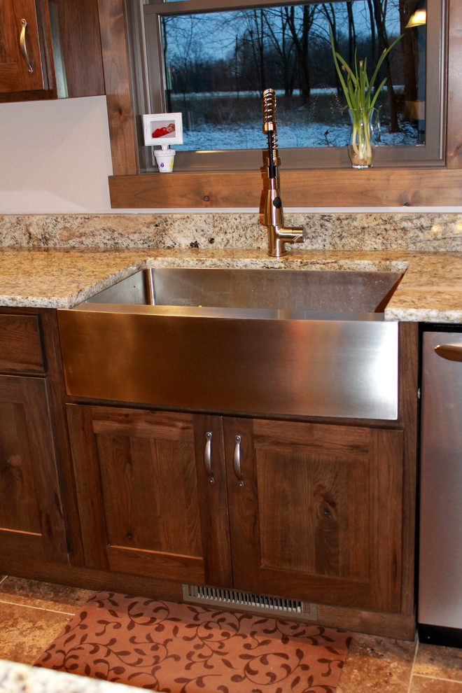 Large mountain style l-shaped eat-in kitchen photo in Chicago with a farmhouse sink, shaker cabinets, dark wood cabinets, granite countertops, stainless steel appliances and an island