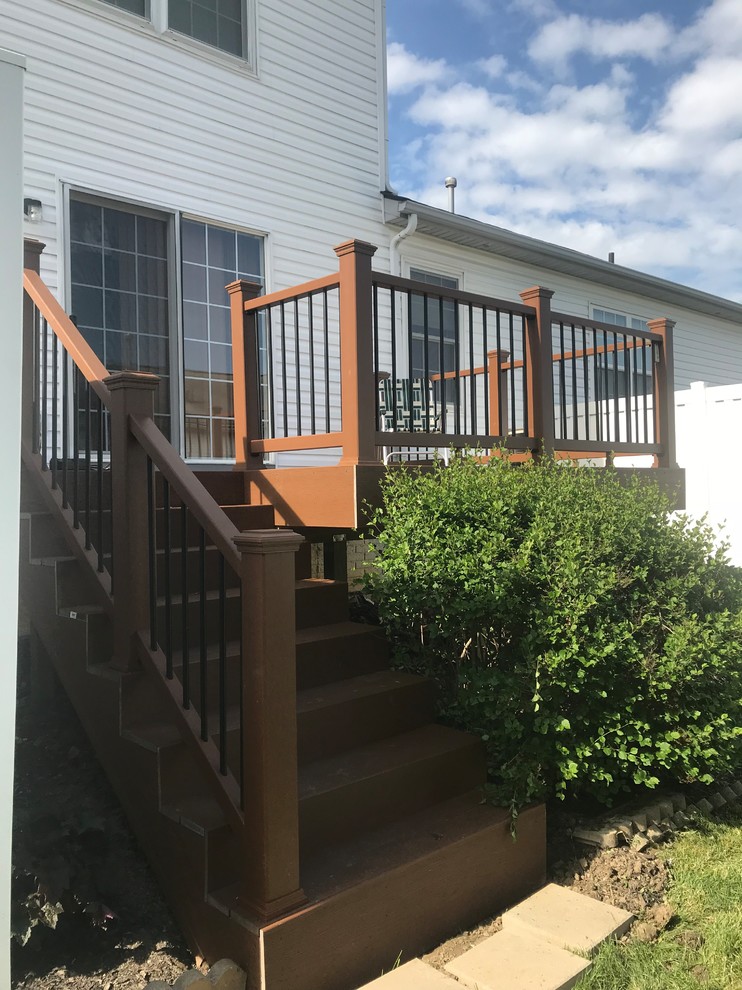 Mid-sized backyard deck photo with no cover