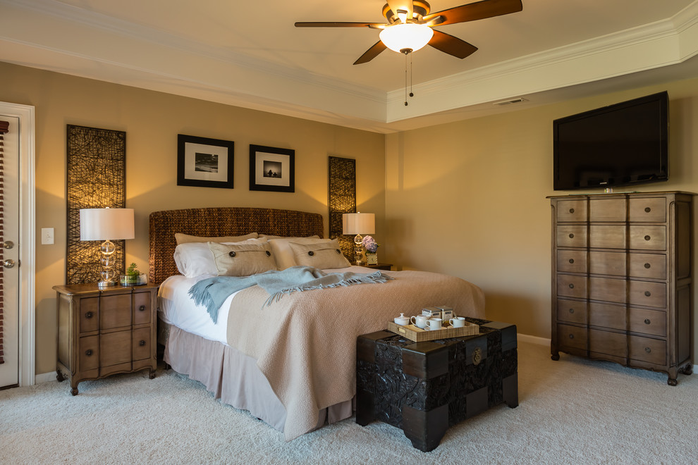 Inspiration for a large transitional master bedroom in Raleigh with beige walls and carpet.