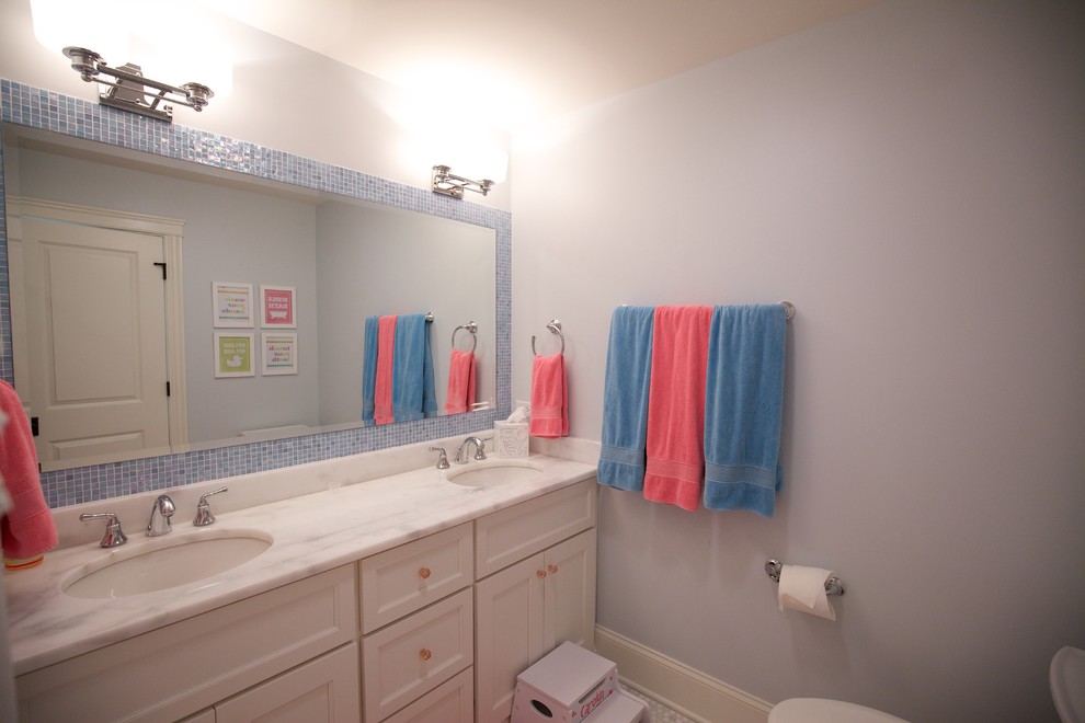 Inspiration for a mid-sized country 3/4 bathroom in Chicago with shaker cabinets, white cabinets, an alcove tub, a two-piece toilet, blue walls, ceramic floors, a drop-in sink, granite benchtops, multi-coloured floor, a shower curtain and white benchtops.