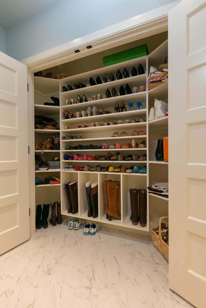 Design ideas for a traditional women's built-in wardrobe in Charleston with open cabinets, white cabinets and ceramic floors.
