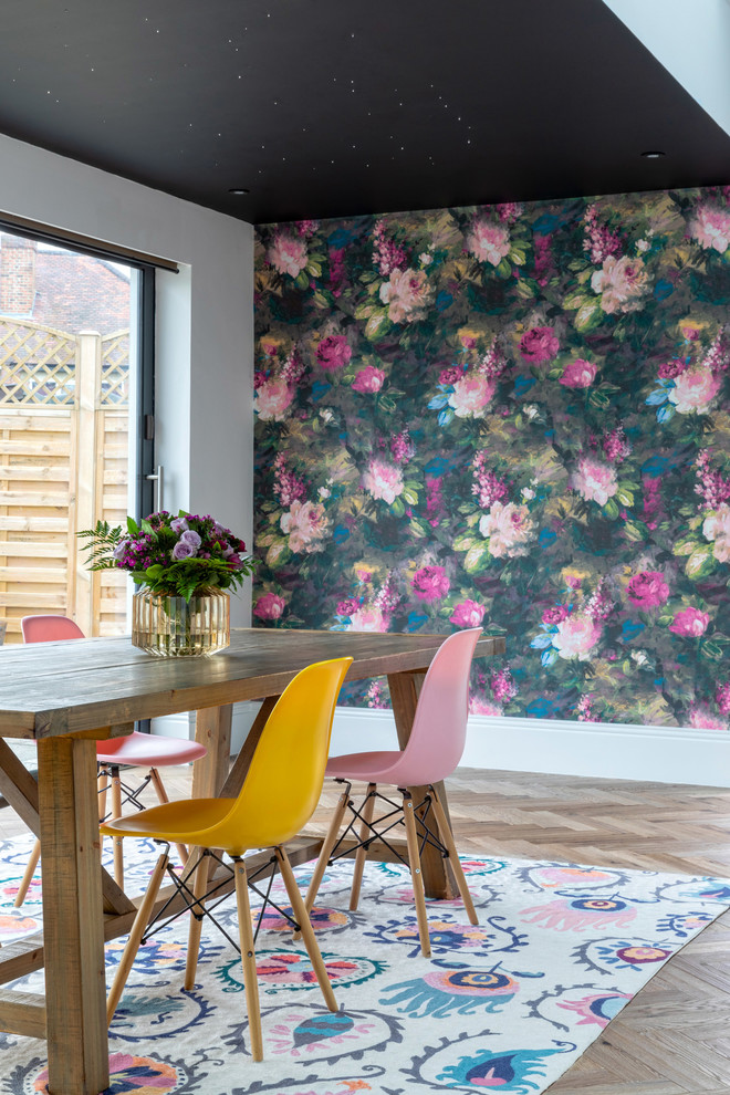Design ideas for a contemporary separate dining room in London with multi-coloured walls, no fireplace and beige floor.