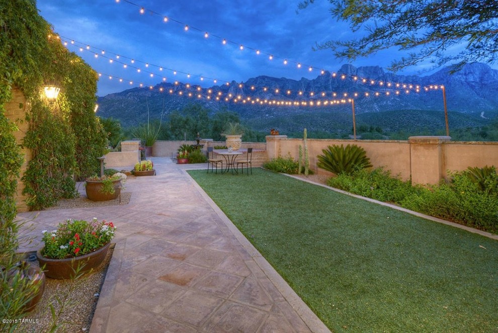 Inspiration for a mid-sized side yard patio in Phoenix with tile, no cover and a container garden.