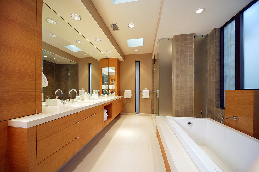 Contemporary bathroom in Dallas with an undermount sink, flat-panel cabinets, medium wood cabinets, a drop-in tub, a corner shower and brown tile.