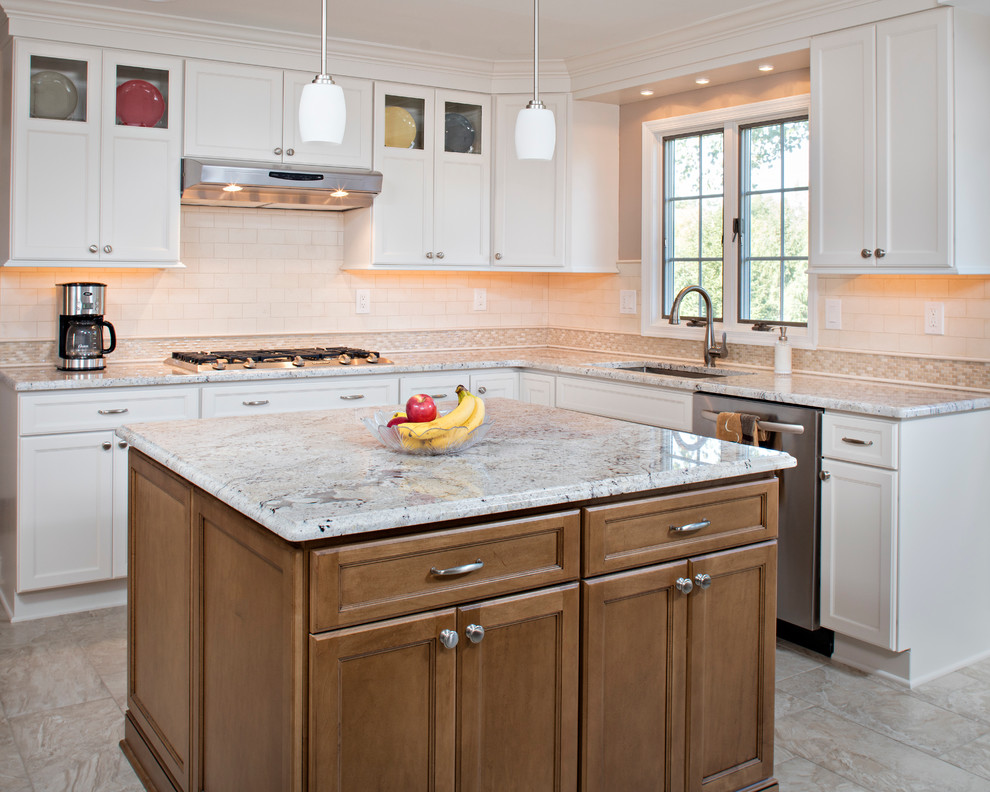 Photo of a large traditional l-shaped eat-in kitchen in Philadelphia with an undermount sink, recessed-panel cabinets, white cabinets, granite benchtops, white splashback, mosaic tile splashback, stainless steel appliances, porcelain floors and with island.