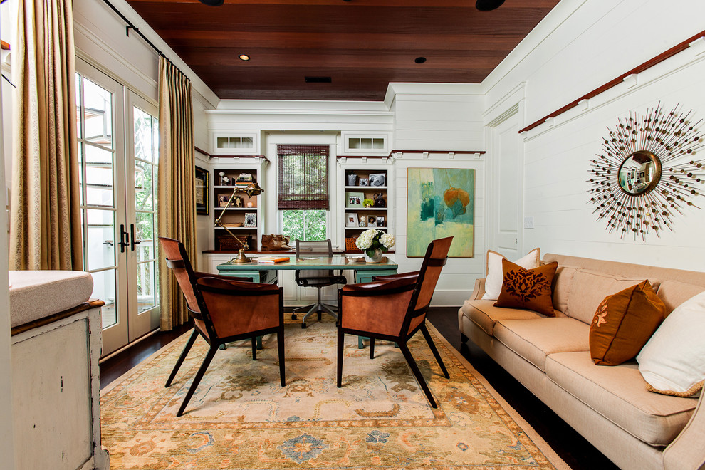 Contemporary home office in Charleston with white walls, dark hardwood floors and a freestanding desk.