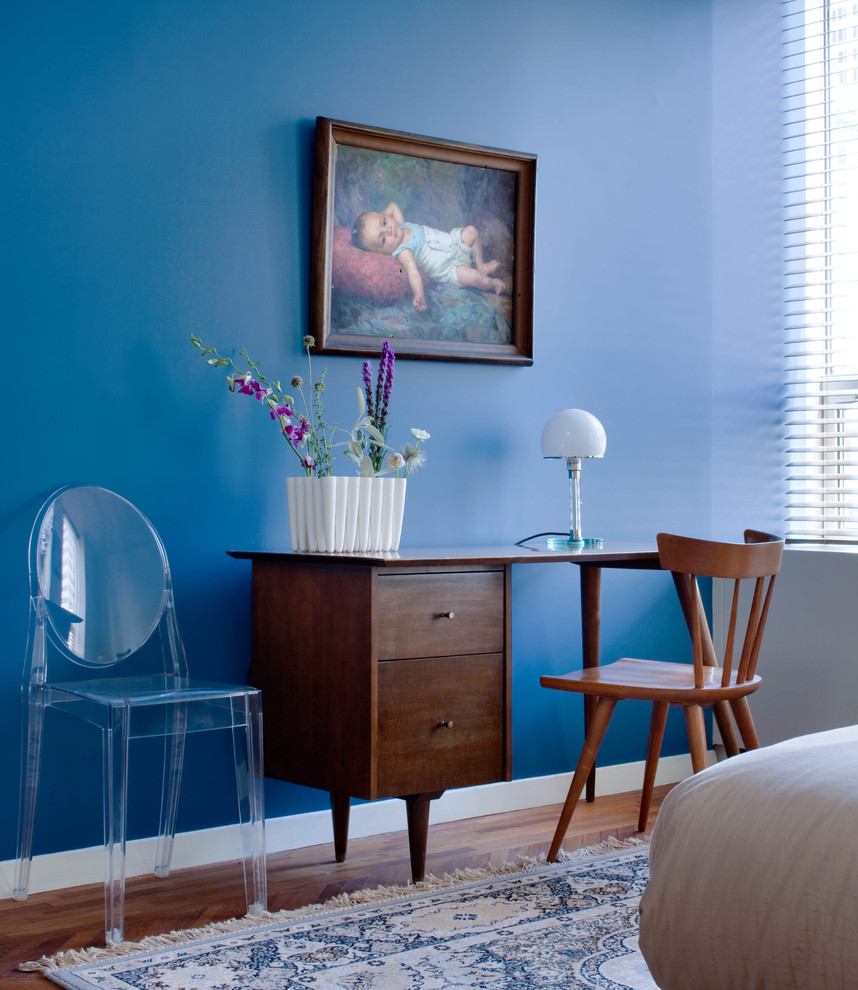 This is an example of a midcentury bedroom in New York with blue walls.