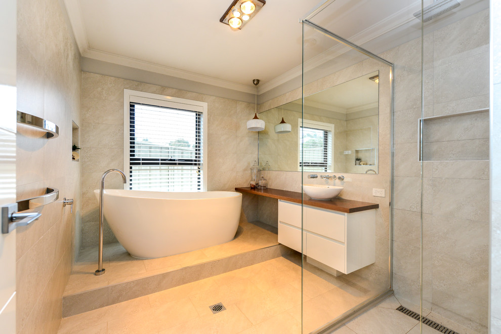 Mid-sized contemporary master bathroom in Other with furniture-like cabinets, white cabinets, a freestanding tub, beige tile, a vessel sink, wood benchtops, beige floor and an open shower.